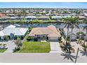 Beautiful aerial view of a waterfront home surrounded by lush landscaping and a tranquil canal at 1137 Treasure Cay Ct, Punta Gorda, FL 33950