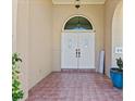 Inviting front entrance with double doors, tiled flooring, and decorative plants offering curb appeal at 1137 Treasure Cay Ct, Punta Gorda, FL 33950