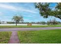 Scenic view of the lake and its surroundings from across the street, with a bench to enjoy the scenery at 1180 39Th N St, St Petersburg, FL 33713
