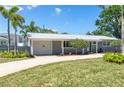 Attractive one-story home with an attached garage, lush lawn, and freshly landscaped front yard at 1183 35Th Ne Ave, St Petersburg, FL 33704