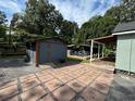 Spacious backyard showcasing shed and an outdoor entertaining deck for ultimate relaxation and enjoyment at 1211 E Curtis St, Tampa, FL 33603