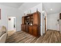 Hallway area featuring wood-look tile and a large hutch at 12815 Tallowood Dr, Riverview, FL 33579