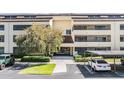 Building entrance featuring well-maintained landscaping, covered parking, and accessible entrance at 13610 S Village Dr # 4212, Tampa, FL 33618