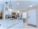 Updated kitchen featuring granite countertops, stainless steel appliances, and modern lighting at 13870 Oakwood Ln # 13870, Seminole, FL 33776