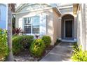 Close up of the front entryway featuring well-manicured landscaping, large windows, and white shutters at 1430 Blue Horizon Cir, Bradenton, FL 34208