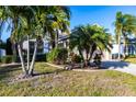 Inviting single-Gathering home featuring well-maintained landscaping and mature palm trees at 1430 Blue Horizon Cir, Bradenton, FL 34208