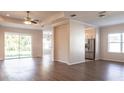 Bright and spacious living room with modern wood-look floors and a ceiling fan at 1430 Blue Horizon Cir, Bradenton, FL 34208