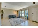 Bright living room featuring neutral walls, a large rug, and bright windows at 1644 Scott St, Clearwater, FL 33755