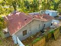 Aerial view of the home, showcasing backyard fencing, lush greenery, and a storage shed at 3212 E Henry Ave, Tampa, FL 33610