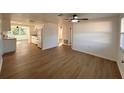 Spacious living room featuring hardwood floors and a ceiling fan at 4623 Irene Loop, New Port Richey, FL 34652