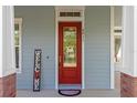 Inviting front door with glass details, complemented by a 'Welcome' sign and attractive exterior accents at 6011 Caldera Ridge Dr, Lithia, FL 33547