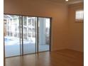 Open living space with large sliding glass doors leading to the screened pool area at 603 5Th S St, Safety Harbor, FL 34695