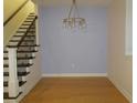 Spacious room with a decorative chandelier, staircase, and hardwood floors at 603 5Th S St, Safety Harbor, FL 34695