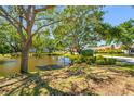 View of the Shady Oaks community sign next to a pond and manicured landscaping at 7080 Nicole Ln, Largo, FL 33771
