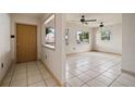 Bright and airy living room featuring tile floors and two ceiling fans at 7141 56Th N St, Pinellas Park, FL 33781