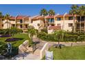 Beautiful condo complex with lush landscaping, palm trees and easy access to all units at 7520 Sunshine Skyway S Ln # 110, St Petersburg, FL 33711