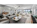 Modern living room with neutral tones, stylish furnishings and expansive water views at 7520 Sunshine Skyway S Ln # 110, St Petersburg, FL 33711
