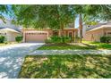 Charming two-story home with a two-car garage and manicured landscaping in a desirable neighborhood at 10617 Lucaya Dr, Tampa, FL 33647