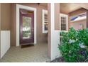 Inviting covered front porch with a stylish door and neutral tones, offering a welcoming entrance at 10617 Lucaya Dr, Tampa, FL 33647