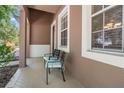 Charming covered front porch with comfortable seating and neutral tones, creating a welcoming entrance at 10617 Lucaya Dr, Tampa, FL 33647