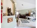 Open-concept living room featuring neutral walls, a zebra rug, and a glimpse into the dining area at 12322 Hawkeye Point Pl, Riverview, FL 33578