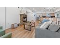 Inviting living room featuring a stone fireplace, wood floors, and modern furnishings at 12384 144Th St, Largo, FL 33774