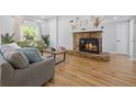 Comfortable living room with stone fireplace, large window and neutral decor at 12384 144Th St, Largo, FL 33774