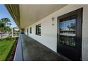 Hallway exterior featuring a black door. The building shows windows, doors and an inviting outdoor space at 124 Nina Way # 24, Oldsmar, FL 34677