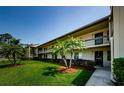 Well-maintained condo exterior with mature landscaping. The building offers private balconies and a welcoming entrance at 124 Nina Way # 24, Oldsmar, FL 34677