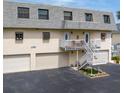 Charming condo featuring a staircase leading to a cozy balcony and attached garage at 12485 2Nd E St # C103, Treasure Island, FL 33706
