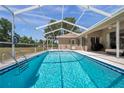 Inviting screened-in pool perfect for relaxation and entertainment on a sunny day at 13290 Don Loop, Spring Hill, FL 34609