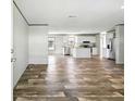Open-concept living space with stainless appliances and modern flooring at 14383 Dehaven Ave, Brooksville, FL 34613