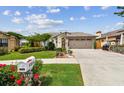 Lovely one-story home with a lush green lawn, lovely flower beds, and a double garage at 1511 Woonsocket Ln, Brandon, FL 33511