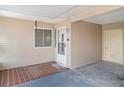 Enclosed front porch with a welcome mat and neutral walls at 1528 Chevy Chase Dr, Sun City Center, FL 33573