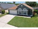 Well-maintained one-story home with verdant lawn, neutral paint and two car garage at 1624 Maximilian Dr, Wesley Chapel, FL 33543