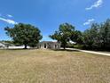 Lovely one-story home featuring a spacious front yard, mature trees, and a long driveway at 17127 Brown Rd, Odessa, FL 33556