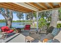 Relaxing outdoor patio featuring stylish furniture and serene water views at 19254 Blount Rd, Lutz, FL 33558