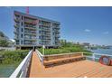 Exterior of waterfront condo building featuring private balconies with scenic views from a waterfront dock at 19925 Gulf Blvd # 503, Indian Shores, FL 33785