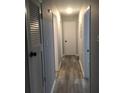 Clean hallway with updated flooring and neutral paint tones, providing access to multiple rooms at 211 Harmony Ln, Brandon, FL 33511