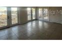 Bright sunroom with tiled floor featuring multiple glass doors offering natural light at 21811 Edgewater Dr, Port Charlotte, FL 33952