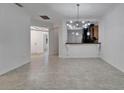 Bright living room showcasing sleek tile flooring, open layout, and modern lighting at 329 Seneca Falls Dr, Apollo Beach, FL 33572