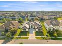 Stunning aerial view of a modern home with manicured lawn in a well-planned community at 33228 Kateland Dr, Wesley Chapel, FL 33545