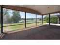 Screened-in porch with tranquil views of a serene lake at 3330 Foxridge Cir, Tampa, FL 33618
