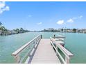 Private wooden dock with railings, offering direct access to the canal and waterways at 455 115Th Ave, Treasure Island, FL 33706
