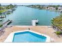 Backyard featuring a private pool, boat dock and waterfront access to the intercoastal at 455 115Th Ave, Treasure Island, FL 33706