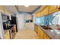 Modern kitchen with stainless steel appliances, granite counters, and bright lighting at 5005 Puritan Rd, Tampa, FL 33617