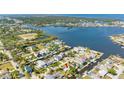 Aerial view showcases the waterfront property with a canal and neighborhood, providing a sense of location and community at 5425 Bluepoint Dr, Port Richey, FL 34668