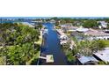 An aerial shot of a canal neighborhood with docks and boat lifts providing direct access to the open waters at 5425 Bluepoint Dr, Port Richey, FL 34668