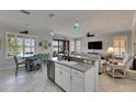 Open-concept kitchen with a center island, granite countertops, and views of the adjacent living areas at 5728 Sunset Falls Dr, Apollo Beach, FL 33572