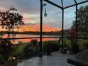 Enjoy the sunset overlooking the lake from the tiled patio at 5728 Sunset Falls Dr, Apollo Beach, FL 33572